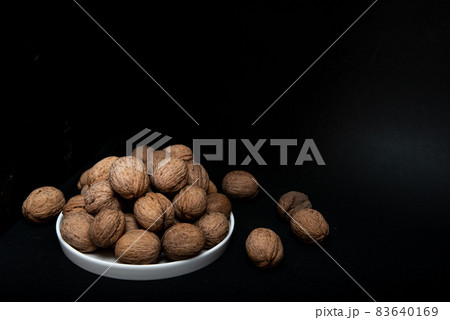 walnut slide on a black background walnut slide on a black background 83640169
