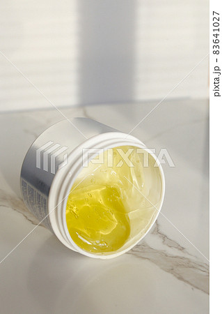 Cosmetic cream container with face or body cream on neutral background Cosmetic cream container with face or body cream on neutral background 83641027