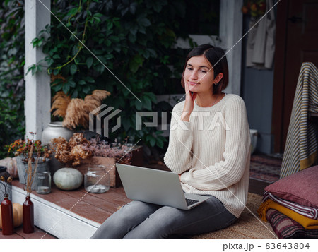 woman with laptop working outdoors in garden 83643804