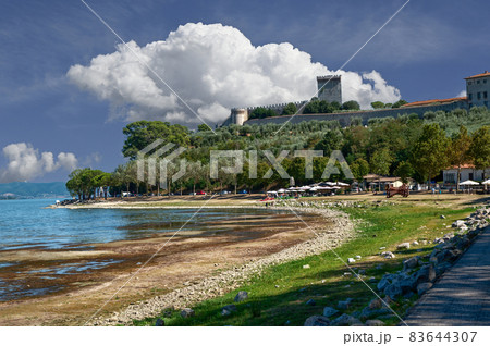 Castiglione del lago, Umbria, Italy. August 2020. Amazing landscape of the Trasimeno lakefront. In the background the historic village with the fort and the tower. 83644307