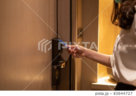 Business woman using key card entering the room in hotel. 83644727