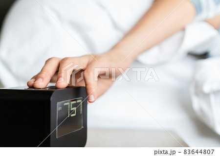 Lazy woman snooze the alarm clock. Lazy woman snooze the alarm clock. 83644807