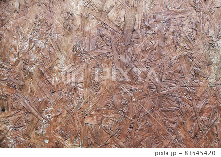 Fiberboard. Compressed light brown wooden texture 83645420
