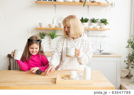 Grandmother and granddaughter having fun together at home. Generation and family concept Grandmother and granddaughter having fun together at home. Generation and family concept 83647789