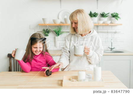 Grandmother and granddaughter having fun together at home. Generation and family concept Grandmother and granddaughter having fun together at home. Generation and family concept 83647790