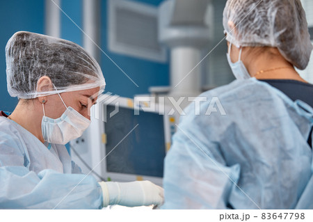 Concentrated Surgical team operating a patient in an operation theater. 83647798