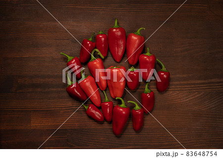 Bunch of peppers and capsicums or bell peppers. Sweet bell, paprika, cayenne, Hungarian wax pepper, isolated on wooden table background. Top view 83648754