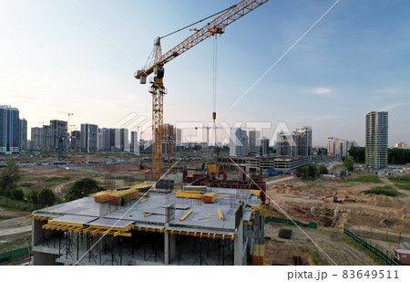 Crane during formworks on construction site. Pouring concrete into formwork. Crane during formworks on construction site. Pouring concrete into formwork. 83649511