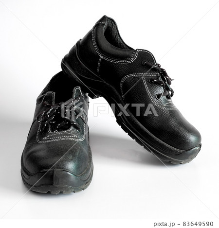 Black and dirty pair of children's shoes on background. Black and dirty pair of children's shoes on background. 83649590