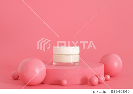 Cosmetic cream packaging standing on pink podium. Cream presentation on the pink background. Mockup. Cosmetic cream packaging standing on pink podium. Cream presentation on the pink background. Mockup. 83649849