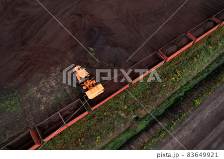 Wheel loader loads peat in freight cars.  83649921