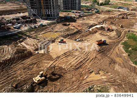 Laying a concrete well ring and sewer pipe at construction site. Earthworks Laying a concrete well ring and sewer pipe at construction site. Earthworks 83649941