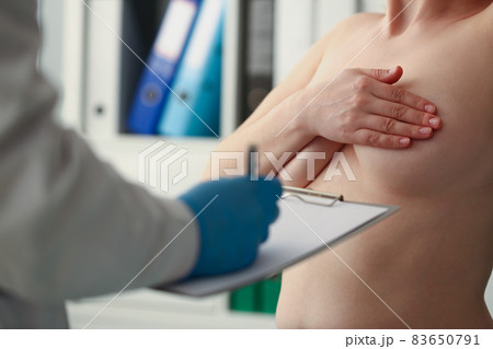 Topless patient in doctors office 83650791