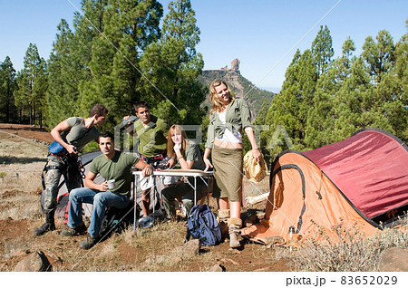 group of hikers in their huts among the pines.  83652029