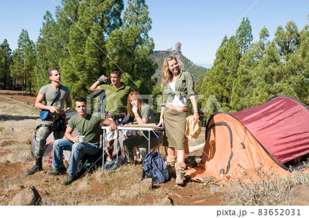 group of hikers in their huts among the pines.  83652031