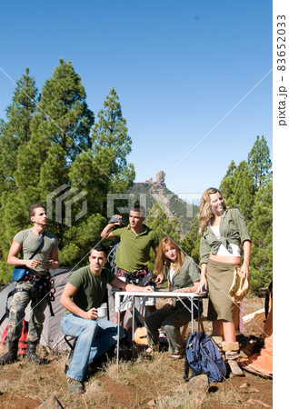 group of hikers in their huts among the pines.  83652033