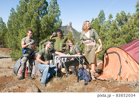 group of hikers in their huts among the pines.  83652034