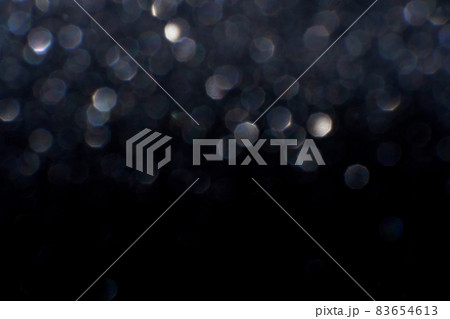 Bokeh circle with silver sparkles background. Grey glitter backdrop. Monochrome 83654613