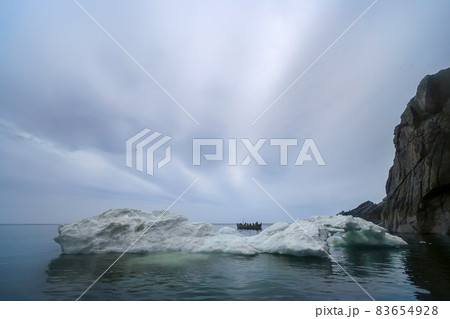 Arctic landscape with a whaleboat among the ice floes in the Bering Strait. Arctic landscape with a whaleboat among the ice floes in the Bering Strait. 83654928