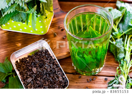 Nettle tea in glass, fresh and dry nettle. Herbal tea. Nettle tea in glass, fresh and dry nettle. Herbal tea. 83655153