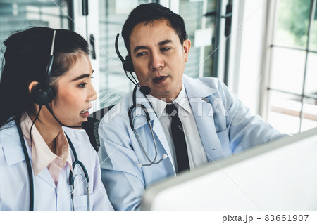 Doctor team wearing headset talking actively on video call in hospital clinic 83661907