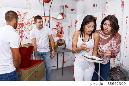 Frightened girls in escape room with traces of blood Frightened girls in escape room with traces of blood 83662309