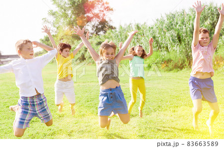 Kids jumping and raising hands 83663589