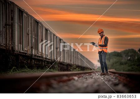 Engineer under discussion inspection and checking construction process railway switch and checking work on railroad station .Engineer wearing safety uniform and safety helmet in work. Engineer under discussion inspection and checking construction process railway switch and checking work on railroad station .Engineer wearing safety uniform and safety helmet in work. 83663653