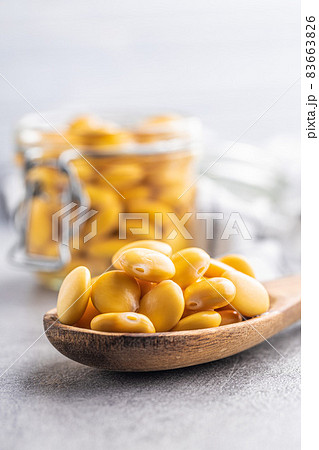 Pickled yellow Lupin Beans in wooden spoon. Pickled yellow Lupin Beans in wooden spoon. 83663826