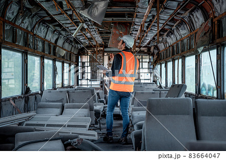 Engineer under discussion inspection and checking construction process railway switch and checking work on railroad station .Engineer wearing safety uniform and safety helmet in work. 83664047