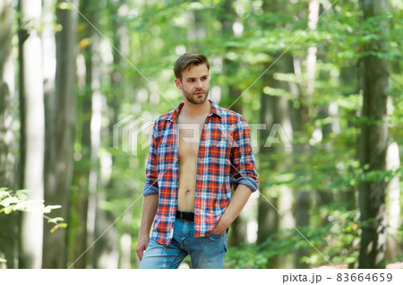 handsome man with bristle wear checkered shirt outdoor, male sexuality 83664659