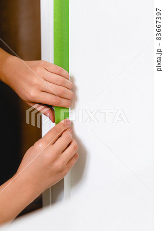 Applaying masking tape to the wall Applaying masking tape to the wall 83667397