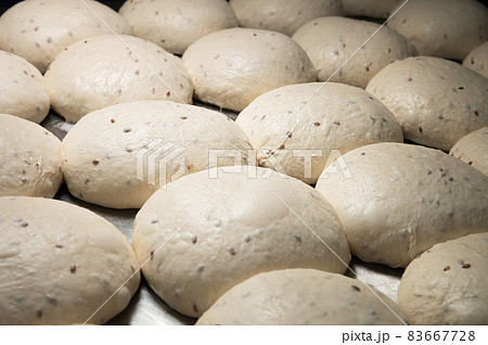Close-up Homemade yeast dough buns for cutlets on a baking sheet. Hamburger buns dough pieces 83667728