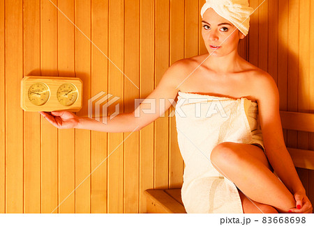 woman relaxing in wooden sauna room 83668698