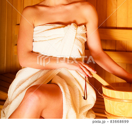 woman relaxing in wooden sauna room woman relaxing in wooden sauna room 83668699