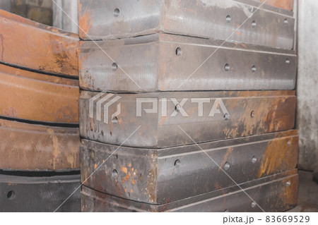 Cast iron tubing reinforced concrete cast products for lining distillation tunnels and underground structures are stored in the warehouse of the industrial plant Cast iron tubing reinforced concrete cast products for lining distillation tunnels and underground structures are stored in the warehouse of the industrial plant 83669529