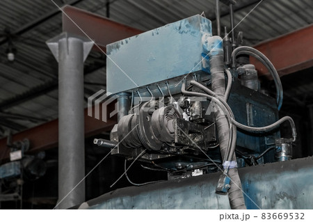 Old machine tools and equipment in the workshop of an industrial plant for metalworking 83669532