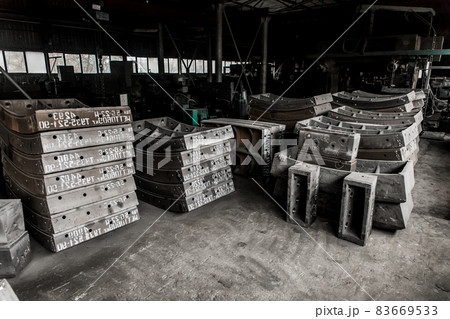 Cast iron tubing reinforced concrete cast products for lining distillation tunnels and underground structures are stored in the warehouse of the industrial plant 83669533