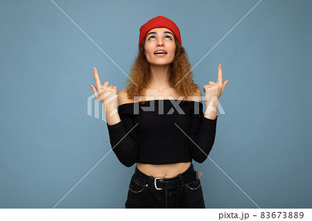 Photo of young surprised amazed attractive brunette curly woman with sincere emotions wearing black Photo of young surprised amazed attractive brunette curly woman with sincere emotions wearing black 83673889