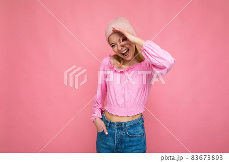 Photo of beautiful happy amusing young blonde female person isolated over pink background wall Photo of beautiful happy amusing young blonde female person isolated over pink background wall 83673893