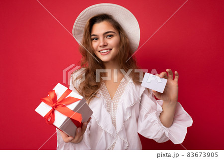 Young beautiful european stylish brunette woman wearing white blouse and fashionable hat isolated Young beautiful european stylish brunette woman wearing white blouse and fashionable hat isolated 83673905