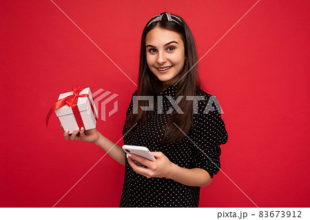 Young winsome beautiful happy smiling brunette woman with sincere emotions wearing black blouse in 83673912