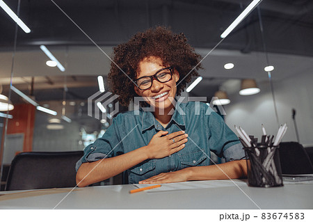 Smiling young Afro American woman speaking sign language Smiling young Afro American woman speaking sign language 83674583