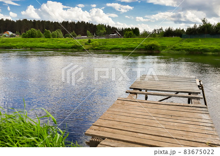 Old wooden pier on the river. Countryside view Old wooden pier on the river. Countryside view 83675022