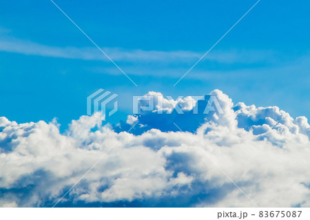 Pure fluffy white clouds on a blue sky. A symbol of purity and dreams. Background for design. Pure fluffy white clouds on a blue sky. A symbol of purity and dreams. Background for design. 83675087