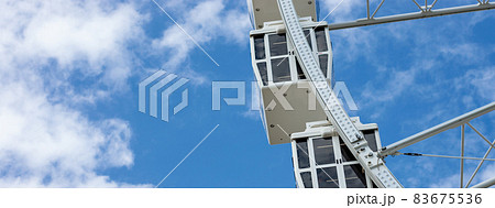 close up ferris wheel cabins with blue sky background 83675536