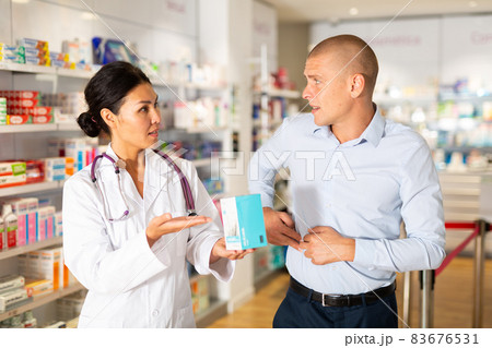Female pharmacist consulting client in drugstore 83676531