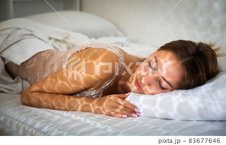 Pretty girl sleeping deeply in bed in morning Pretty girl sleeping deeply in bed in morning 83677646