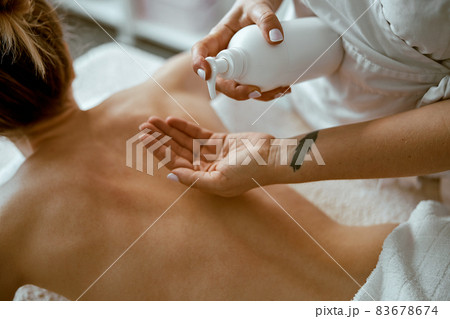 confident female specialist is doing relaxing body massage for beautyful slim caucasian lady at minimalistic spa salon confident female specialist is doing relaxing body massage for beautyful slim caucasian lady at minimalistic spa salon 83678674