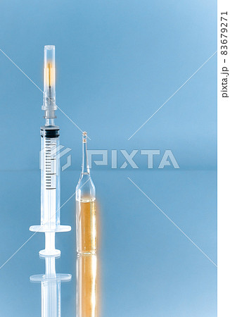 Vertically upwards directed syringe and ampoule with gold medicine. 83679271